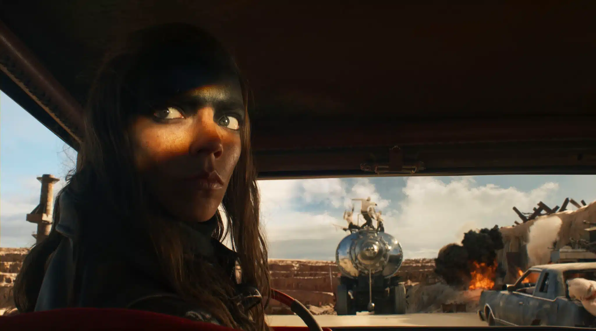 Copyright by Warner Bros. Pictures. Furiosa driving behind the War Rig